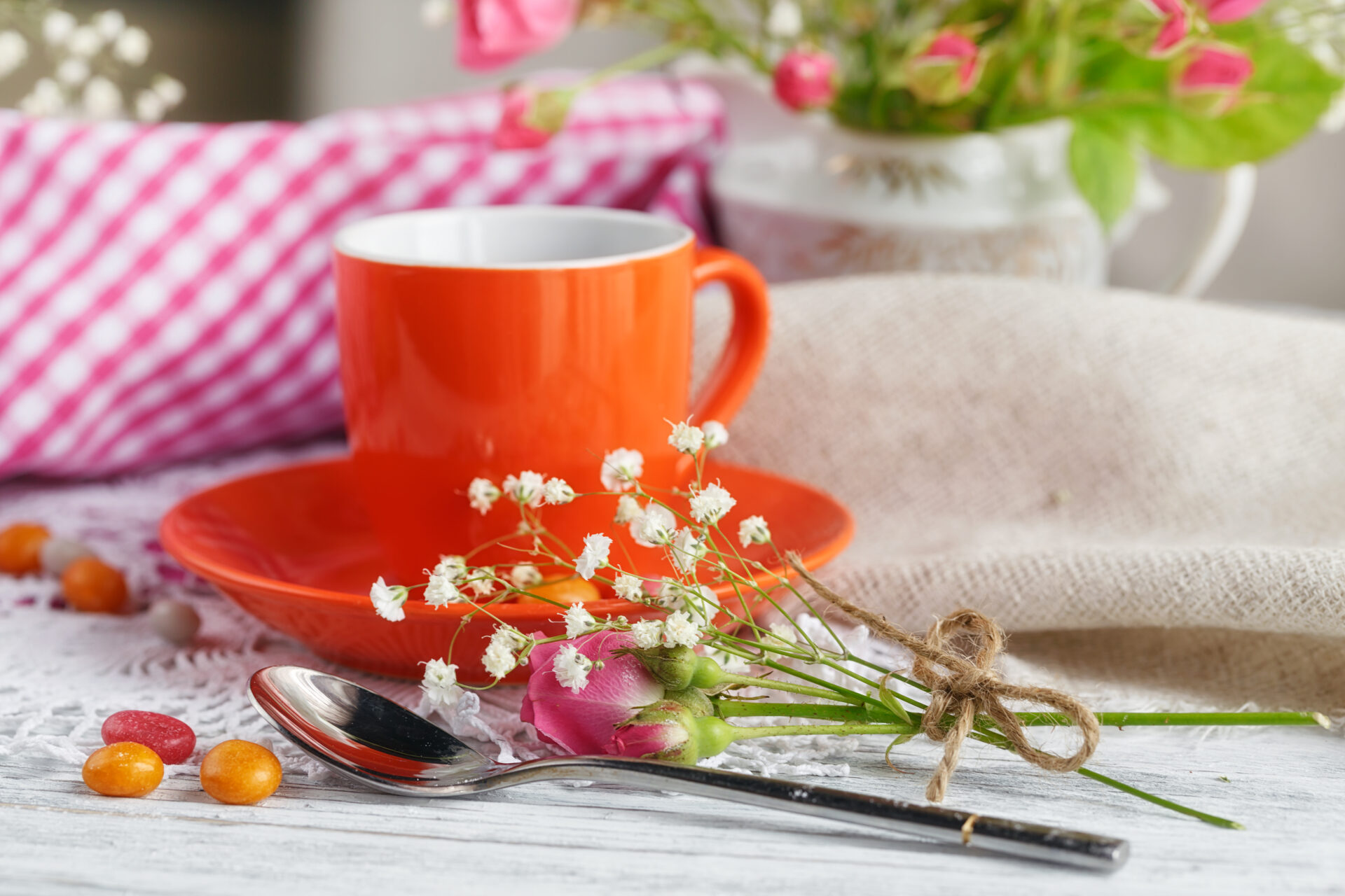 Cup of coffee and croissant with roses